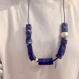 Pursuit of Happiness locally-made rubber and metal organic necklace.